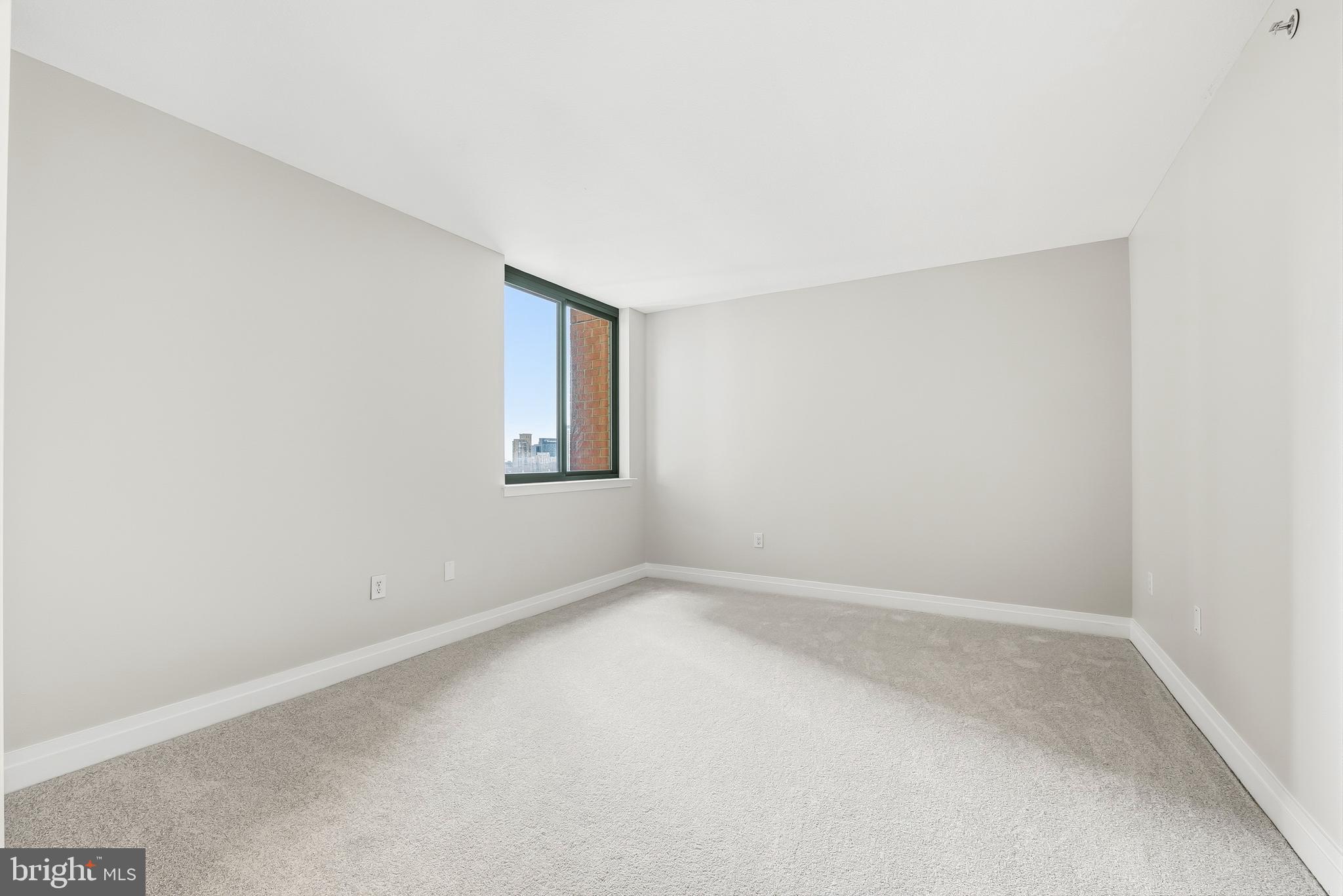 414 Water Street, Unit 1501 Baltimore, MD 21202 - Photo 19 of 35 a view of an empty room with a window