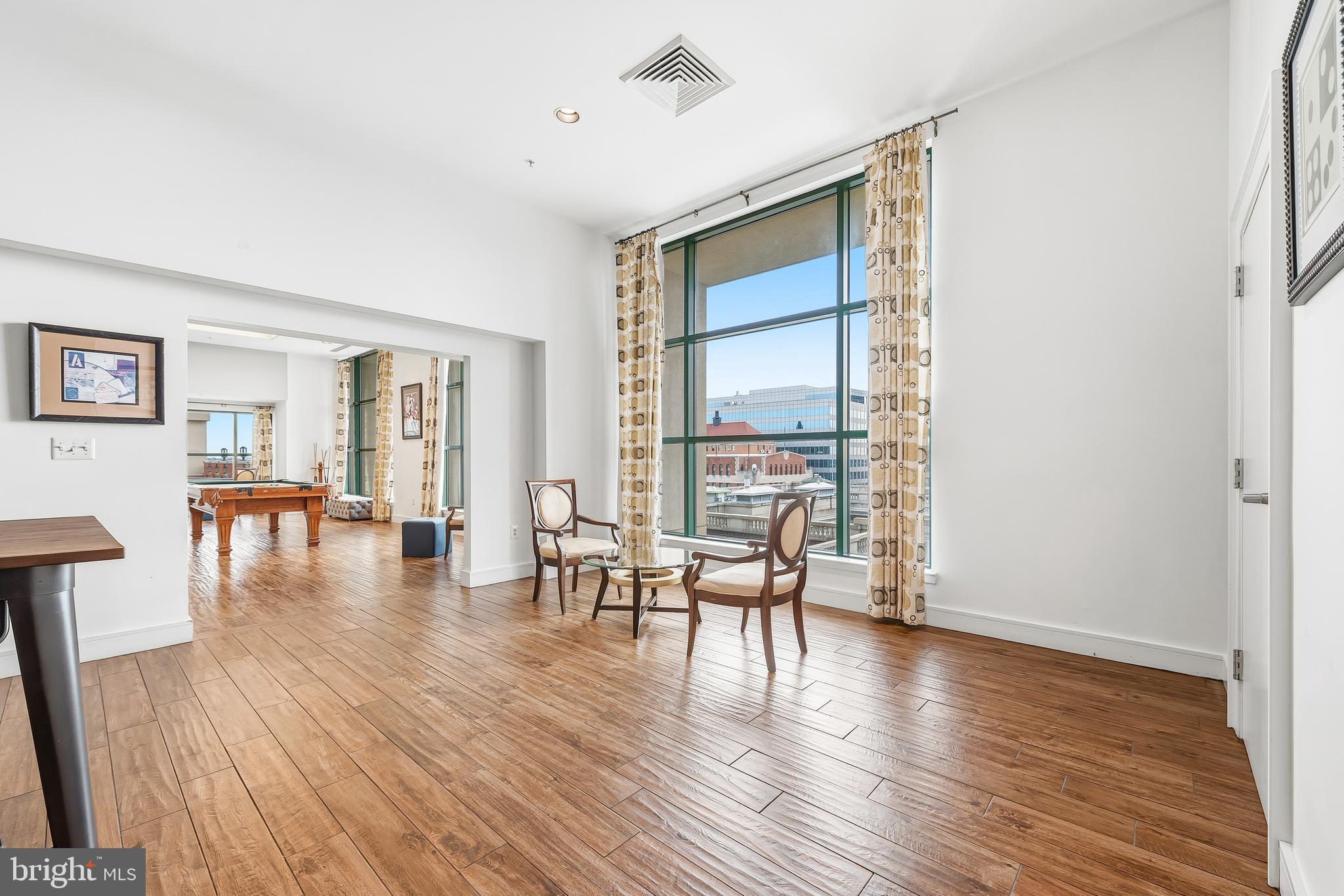 414 Water Street, Unit 1501 Baltimore, MD 21202 - Photo 32 of 35 a living room with furniture wooden floor and a large window