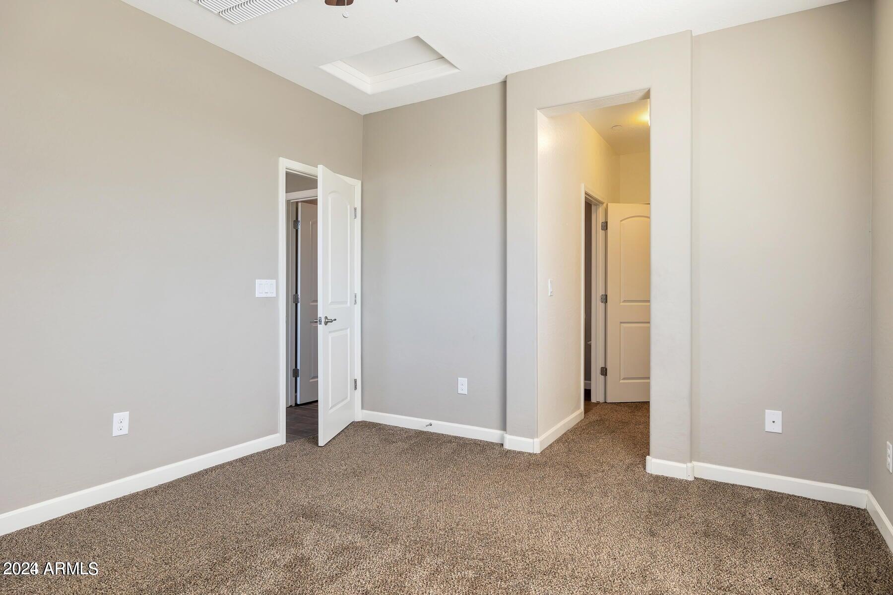 2150 West Alameda Road, Unit 1169 Phoenix, AZ 85085 - Photo 13 of 26 an empty room with closet and a bathroom