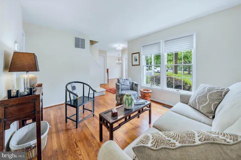 a living room with furniture and a lamp