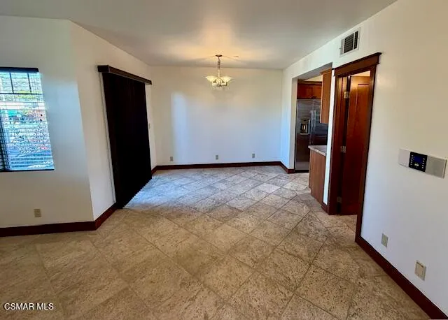 an empty room with closet and windows