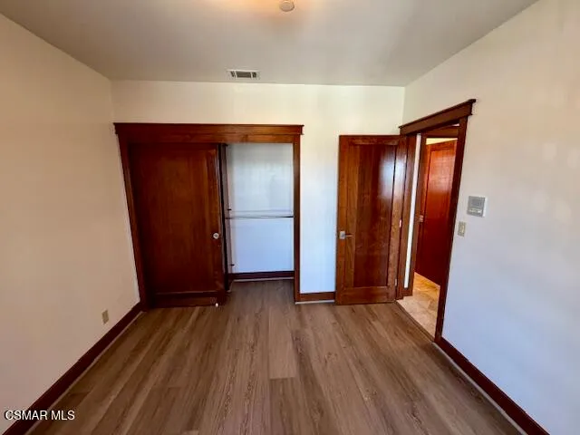 a view of a room with wooden floor