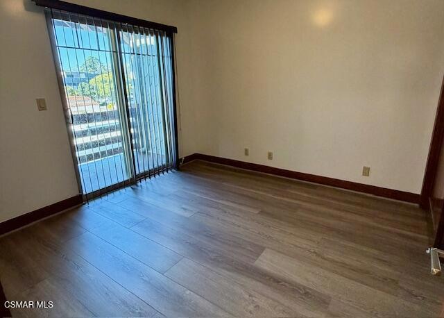 828 East Thompson Boulevard, Unit D Ventura, CA 93001 - Photo 15 of 24 a view of an empty room with wooden floor and a window
