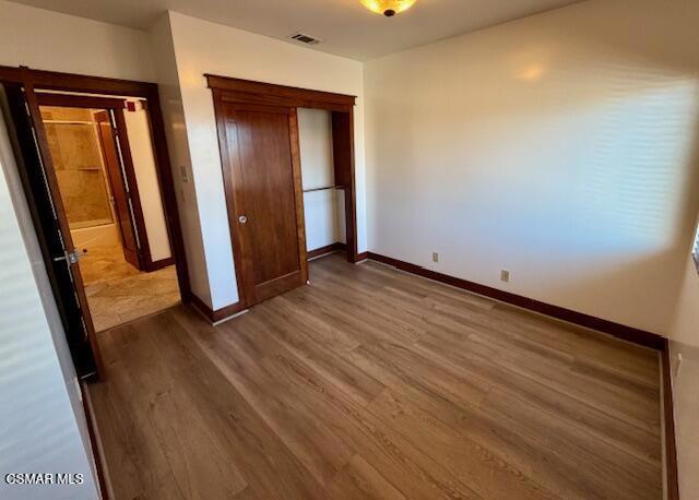 828 East Thompson Boulevard, Unit D Ventura, CA 93001 - Photo 16 of 24 an empty room with wooden floor and mirror