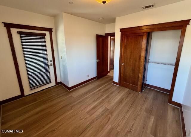 828 East Thompson Boulevard, Unit D Ventura, CA 93001 - Photo 17 of 24 an empty room with wooden floor and closet