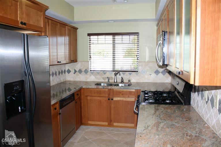 828 East Thompson Boulevard, Unit D Ventura, CA 93001 - Photo 3 of 24 a kitchen with stainless steel appliances granite countertop a sink stove and refrigerator
