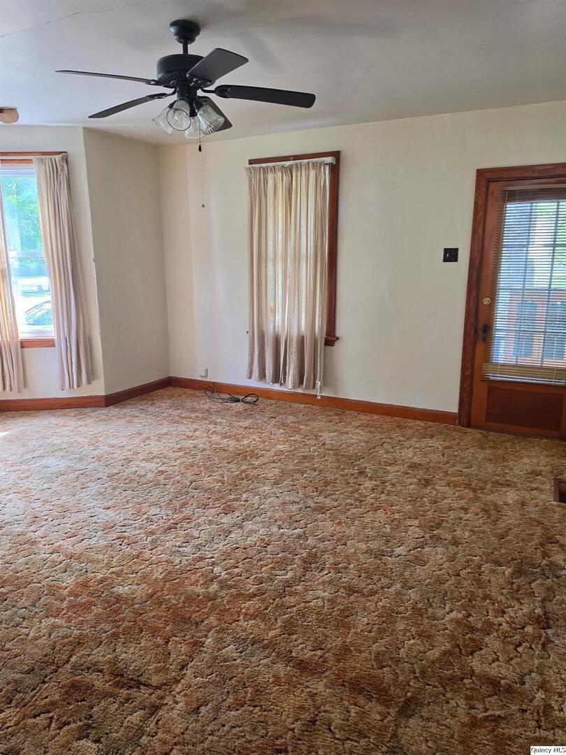 304 West 3rd Street Golden, IL 62339 - Photo 4 of 18 an empty room with windows and fan