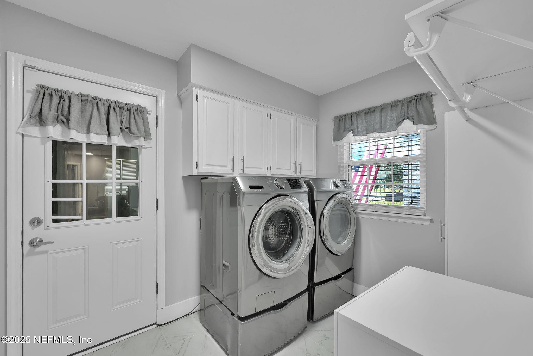 3043 Nautilus Road Middleburg, FL 32068 - Photo 28 of 45 a utility room with dryer and washer