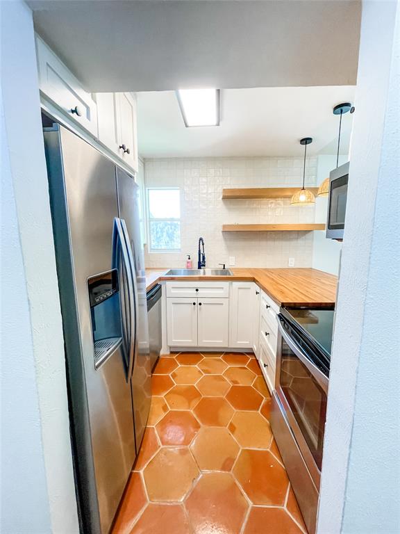 4224 Rawlins Street Dallas, TX 75219 - Photo 11 of 28 a kitchen with white cabinets and refrigerator