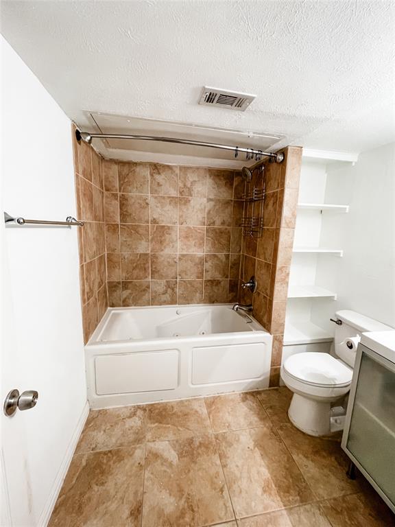4224 Rawlins Street Dallas, TX 75219 - Photo 15 of 28 a bathroom with a toilet a sink and bathtub