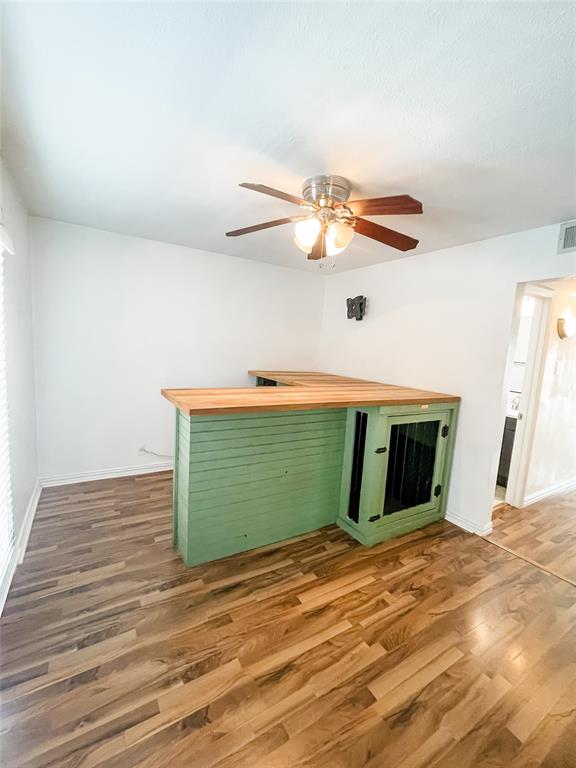 4224 Rawlins Street Dallas, TX 75219 - Photo 18 of 28 a view of a room with wooden floor and a ceiling fan