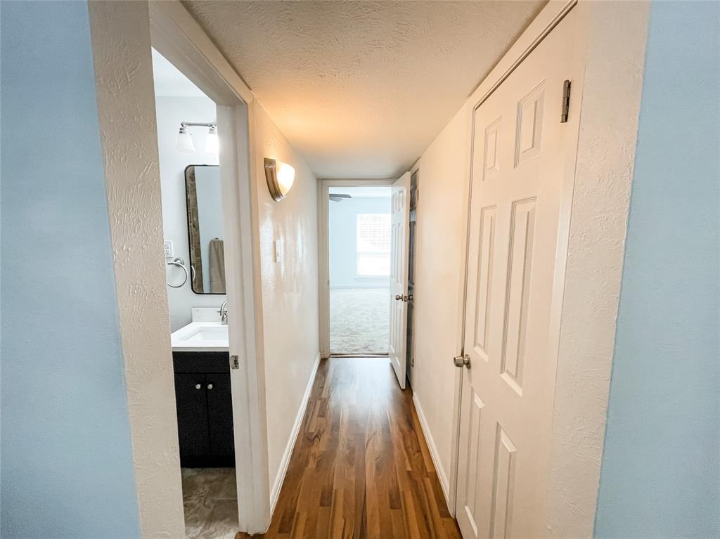 4224 Rawlins Street Dallas, TX 75219 - Photo 21 of 28 a view of a hallway with wooden floor and staircase