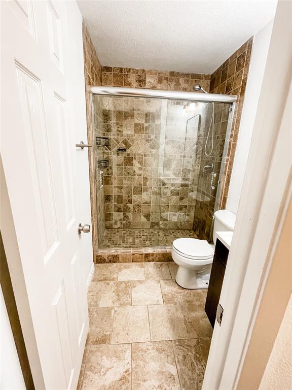4224 Rawlins Street Dallas, TX 75219 - Photo 22 of 28 a bathroom with a toilet and a shower