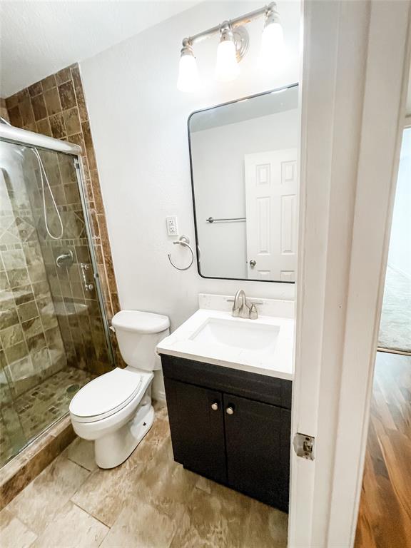 4224 Rawlins Street Dallas, TX 75219 - Photo 23 of 28 a bathroom with a sink toilet and mirror