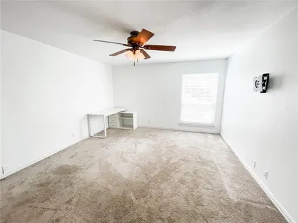 a view of a room with a ceiling fan