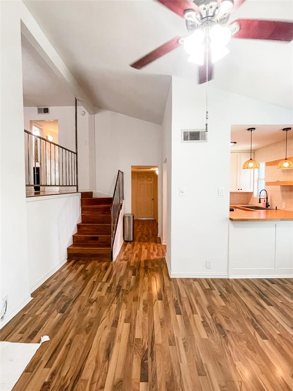 4224 Rawlins Street Dallas, TX 75219 - Photo 5 of 28 a view of a bedroom with wooden floor and staircase