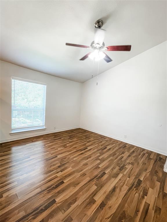 4224 Rawlins Street Dallas, TX 75219 - Photo 9 of 28 an empty room with wooden floor fan and windows