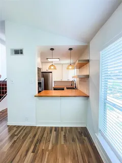a kitchen with white cabinets and refrigerator