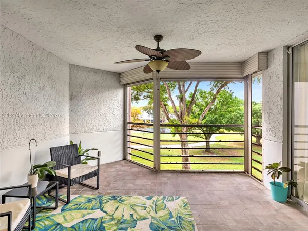 a view of a livingroom with furniture and a floor to ceiling window