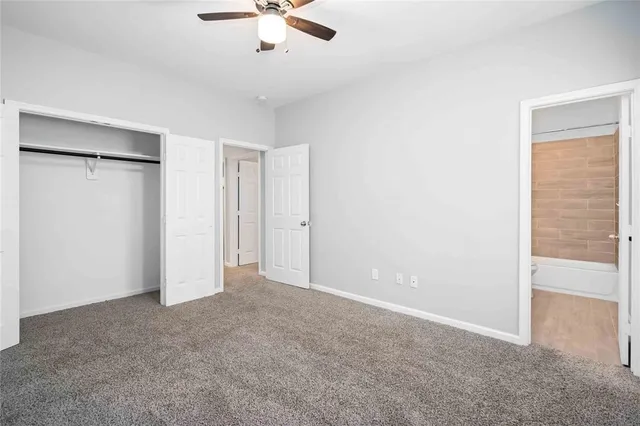 a view of an empty room with a ceiling fan