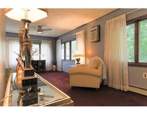 32 Woodland Road Billerica, MA 01821 - Photo 2 of 19 a living room with furniture gym equipment and a large window