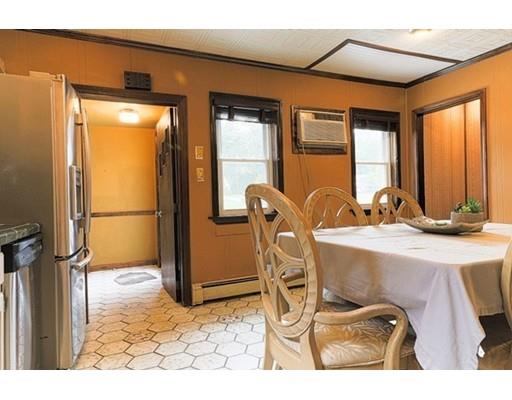 32 Woodland Road Billerica, MA 01821 - Photo 3 of 19 a room with table chairs and a refrigerator