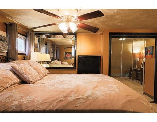 32 Woodland Road Billerica, MA 01821 - Photo 6 of 19 a large bedroom with a bed and a chandelier