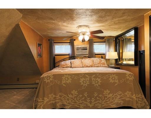 32 Woodland Road Billerica, MA 01821 - Photo 7 of 19 a bedroom with a bed and a chandelier
