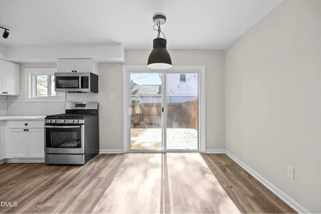 a kitchen with a stove and a refrigerator