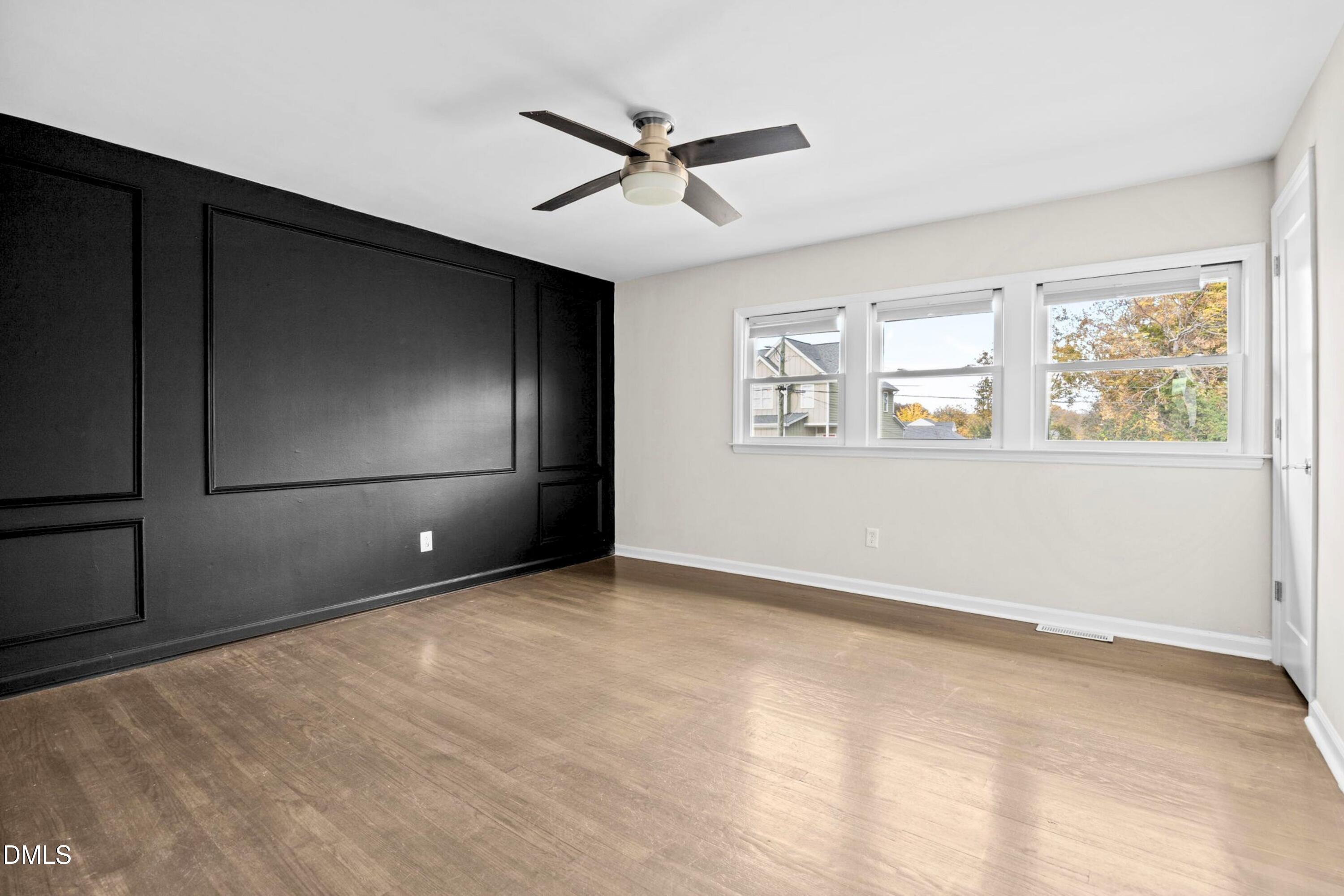 1618 Boyer Street Raleigh, NC 27610 - Photo 14 of 24 an empty room with windows and ceiling fan