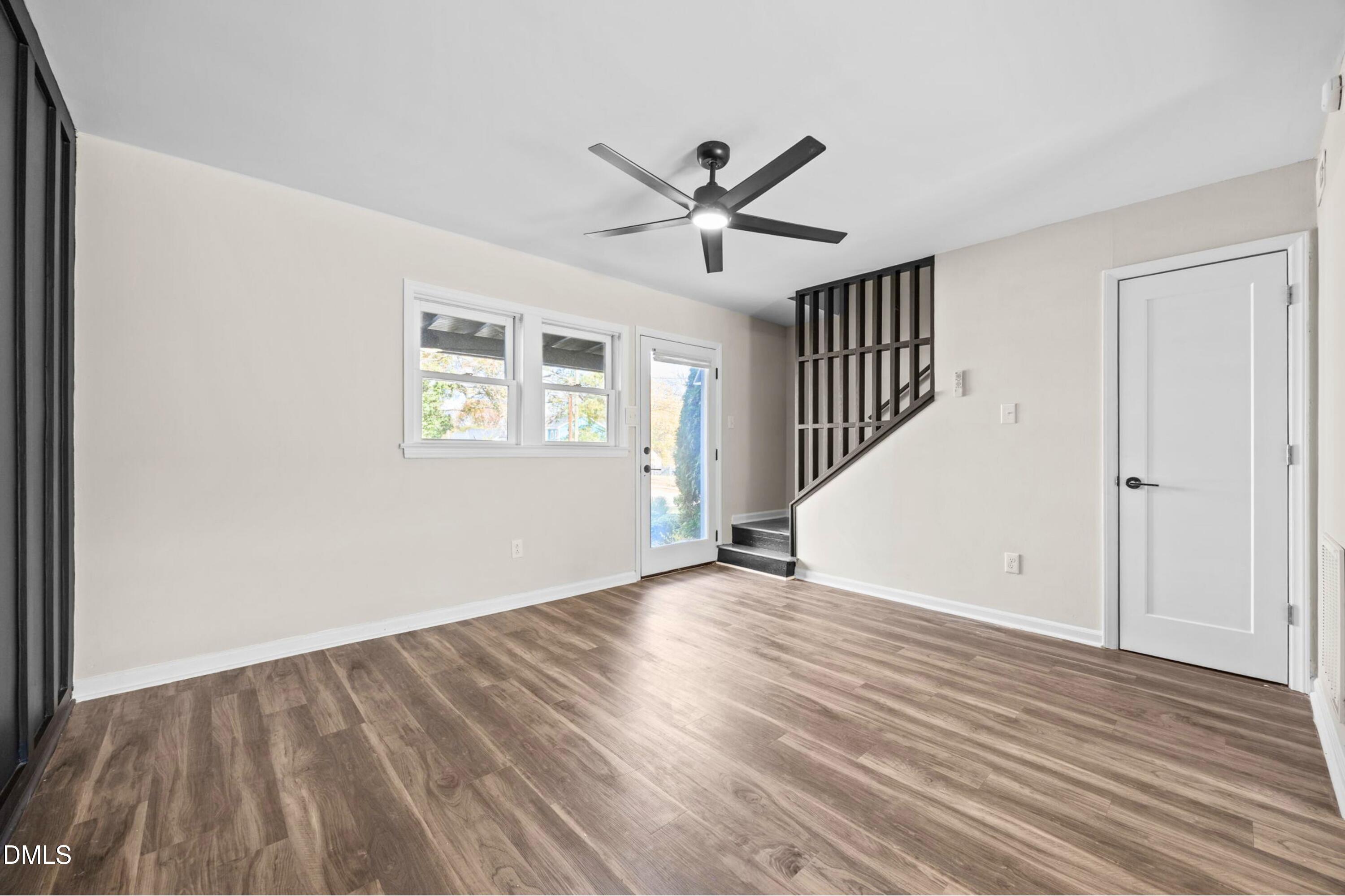 1618 Boyer Street Raleigh, NC 27610 - Photo 4 of 24 wooden floor in an empty room with a window