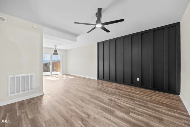 a view of an empty room with wooden floor
