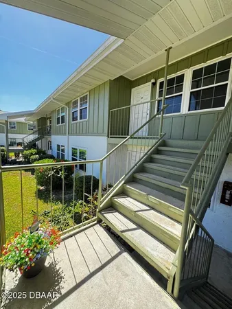 a view of house with swimming pool and outdoor seating