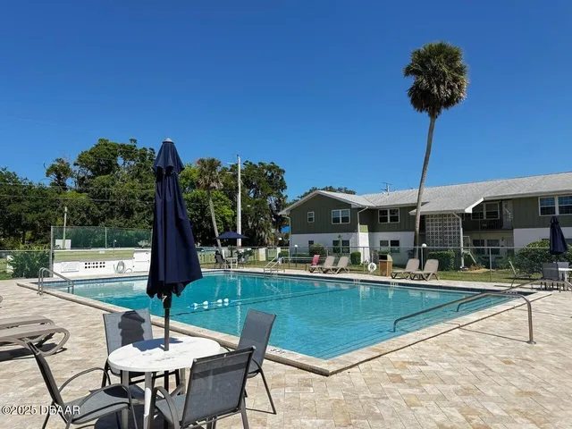a living room with furniture and a book shelf