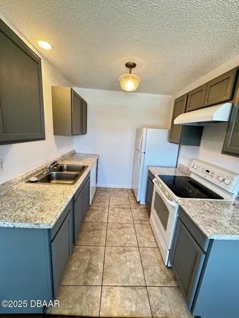 a kitchen with a stove and a sink