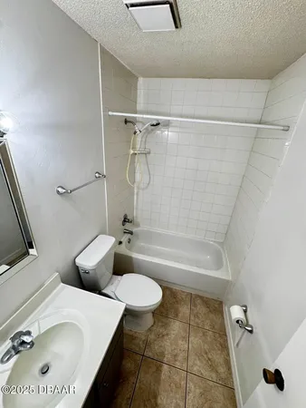 a bathroom with a tub sink toilet and a mirror