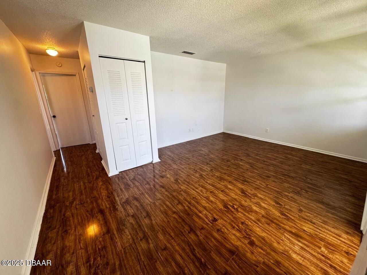 840 Center Avenue, Unit 980 Holly Hill, FL 32117 - Photo 6 of 13 wooden floor in an empty room