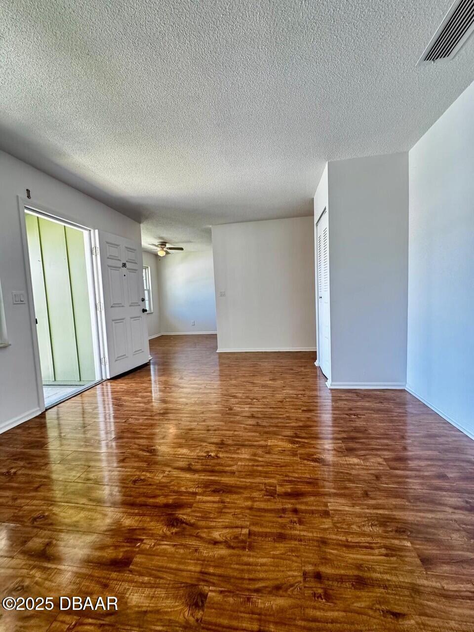 840 Center Avenue, Unit 980 Holly Hill, FL 32117 - Photo 9 of 13 a view of empty room with wooden floor
