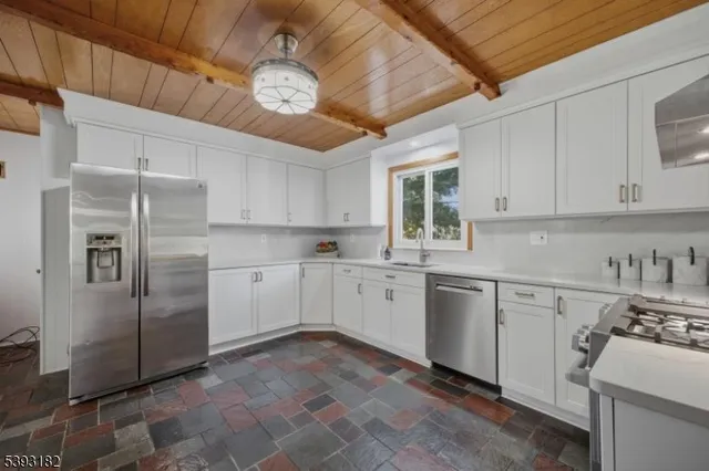 a kitchen with cabinets and stainless steel appliances