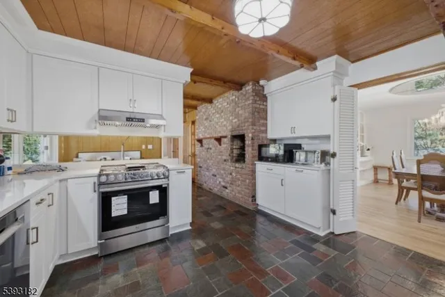 a kitchen with cabinets appliances and a dining table