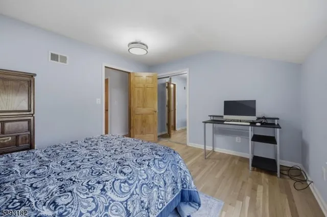 a bedroom with a bed and a television