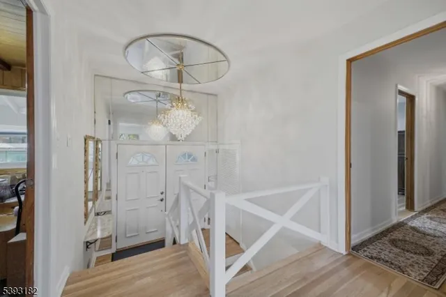a view of a livingroom with wooden floor and entryway