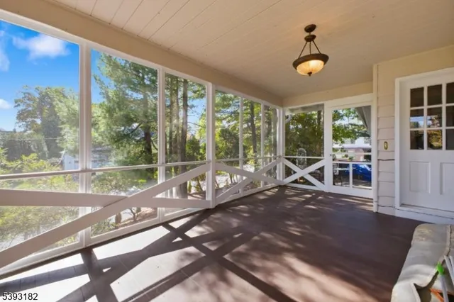 a view of a porch with chairs and backyard