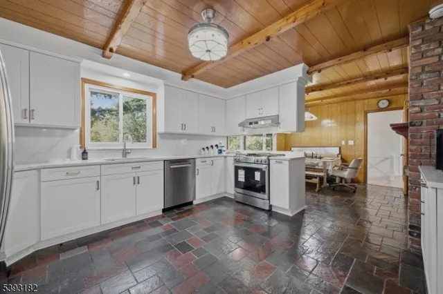a kitchen with a stove window and a refrigerator