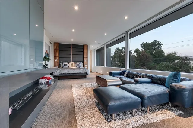 a living room with furniture gym equipment and a large window