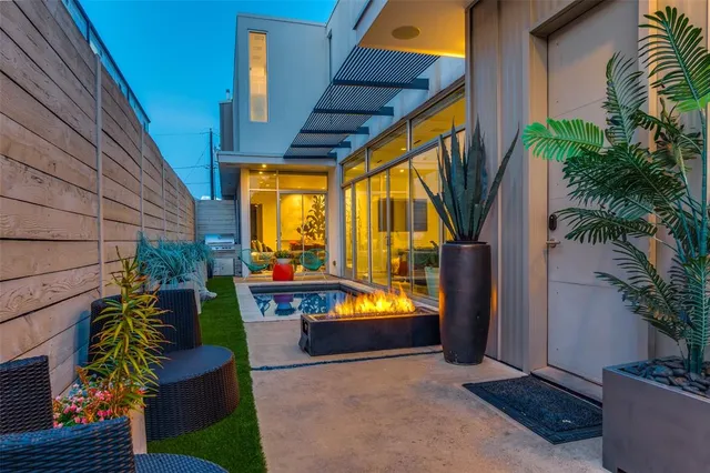 a view of a swimming pool with a patio and a backyard