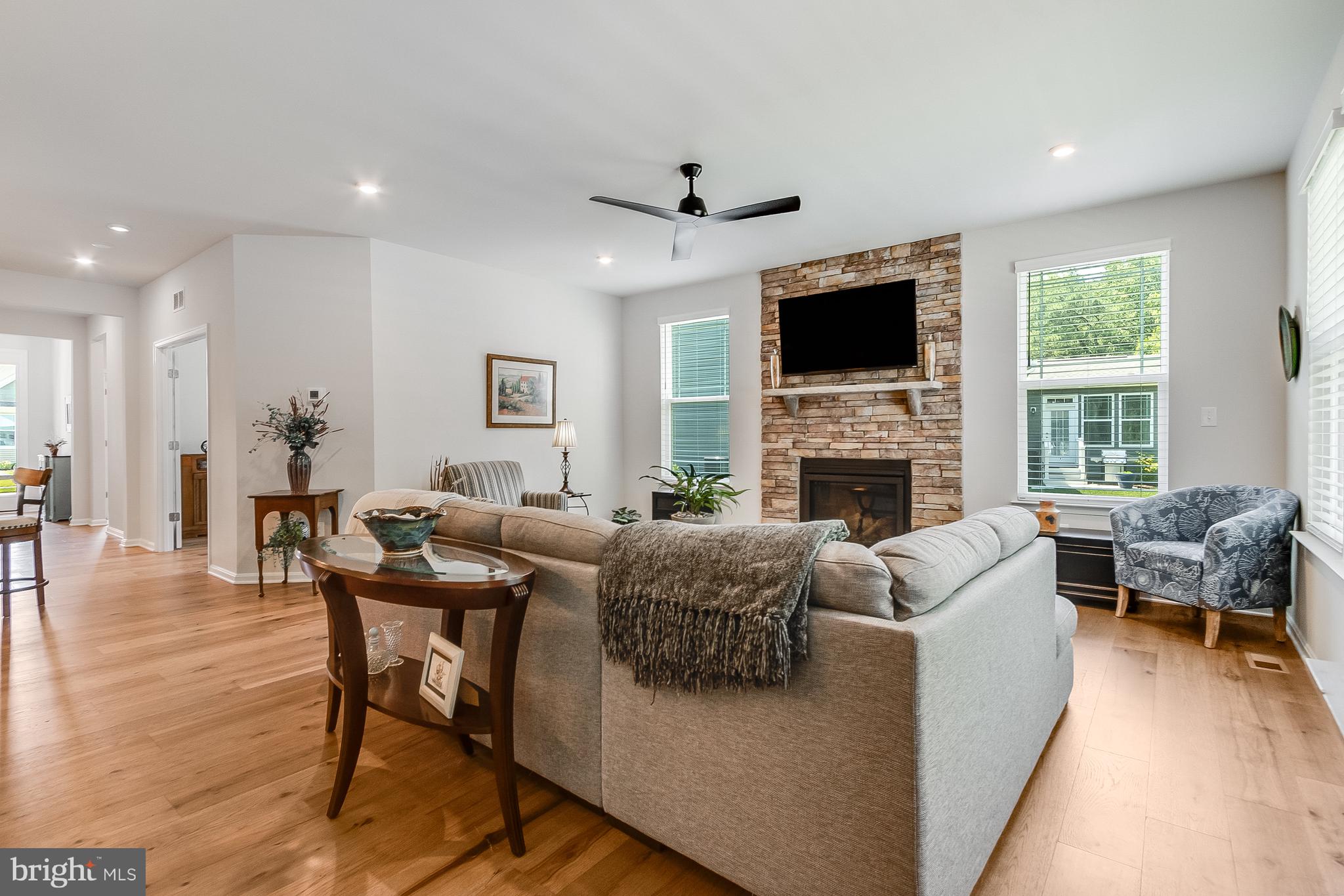 13091 Laurel Leaf Drive Lewes, DE 19958 - Photo 12 of 77 a living room with furniture a flat screen tv and a fireplace