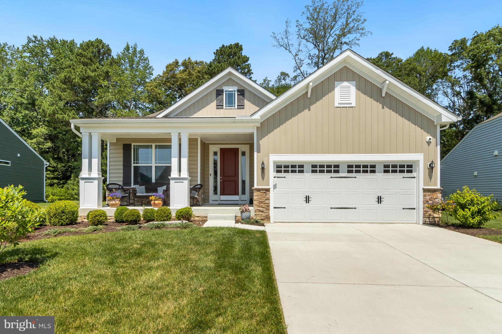 13091 Laurel Leaf Drive Lewes, DE 19958 - Photo 46 of 77 a view of white house with a yard potted plants and a table