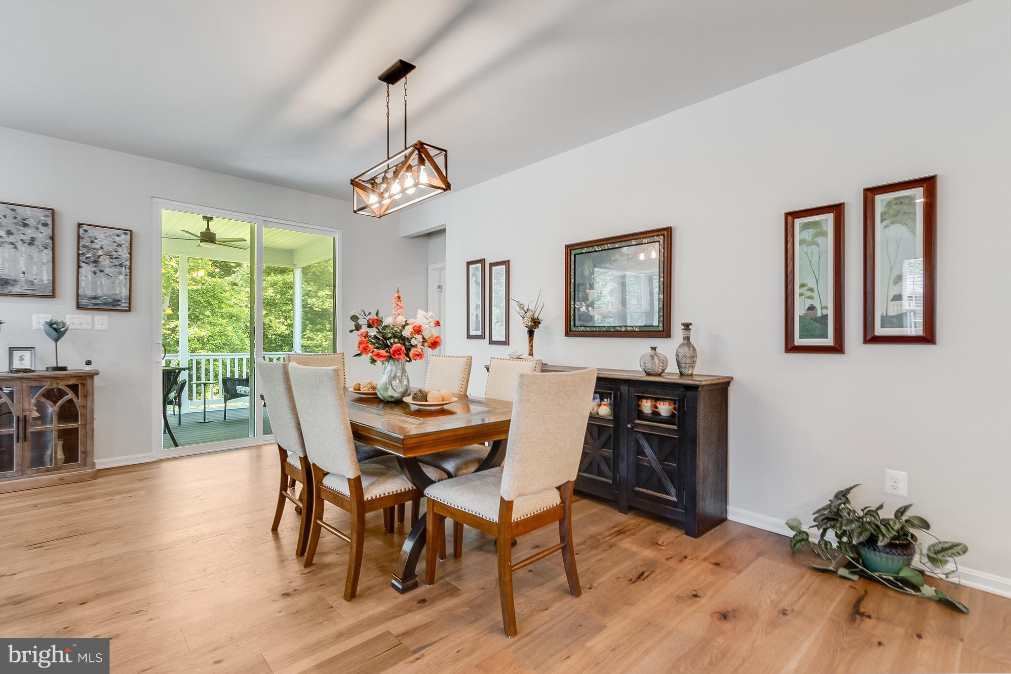 13091 Laurel Leaf Drive Lewes, DE 19958 - Photo 10 of 77 a view of a dining room with furniture window and wooden floor