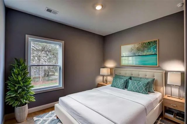 a bedroom with a large bed and a window